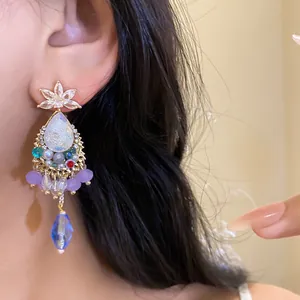 Detailed close-up of a vintage court-style teardrop earring with zircon and crystal tassels.