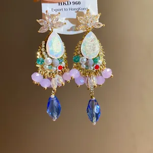 Close-up of vintage teardrop earrings with crystals and colorful beads