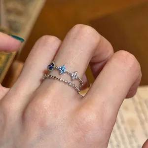 Close-up view of a double-layered ring with blue and clear star-shaped cubic zirconia