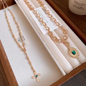 Luxury vintage gold metal cross and sunburst pendant necklaces in retro palace style