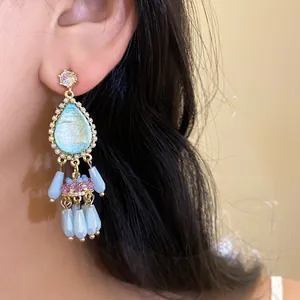 Close-up of vintage palace style waterdrop tassel earrings with crystal zircon beads.
