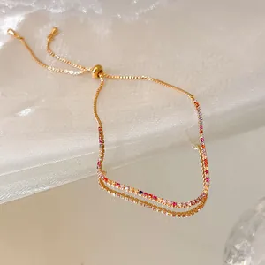 Elegant 18k gold plated adjustable bracelet featuring vibrant zircons on a reflective surface