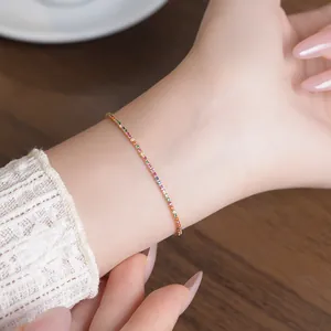 Detailed close-up of 18k gold plated rainbow zircon adjustable bracelet on wrist