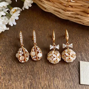 Elegant 14k gold plated teardrop earrings featuring cat's eye stones and shimmering crystals