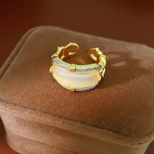 Vintage gold hollow open ring with zircon edges and a large creamy cabochon stone