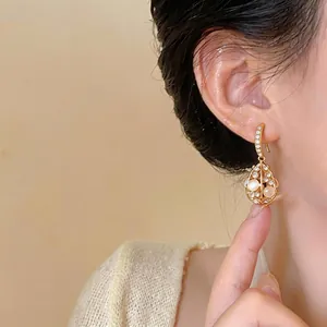 Exquisite 14k gold-plated waterdrop earrings featuring rhinestones and cat eye stones.