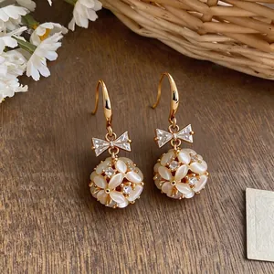 Exquisite 14k gold plated bow earrings featuring cat eye stone floral sphere drops