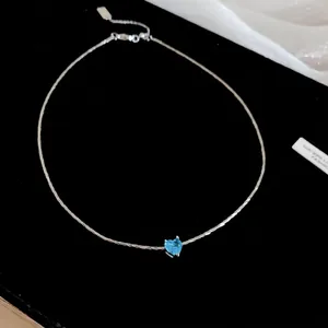 French style silver choker necklace with a brilliant blue heart-shaped zircon pendant
