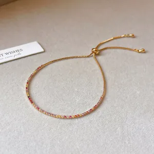 Detail view of 18k gold plated bracelet featuring a row of colorful rainbow zircons