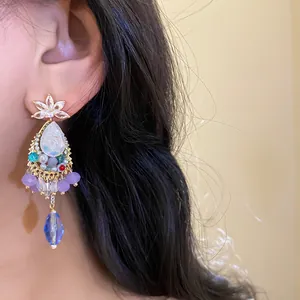 Elegant vintage palace style zircon crystal teardrop tassel earrings shown on model.