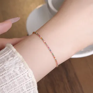 Detailed view of elegant 18k gold plated rainbow zircon tennis bracelet on a wrist