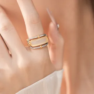 Close-up detail of vintage palace-style ring with rectangular amber stone and pavé zirconia.