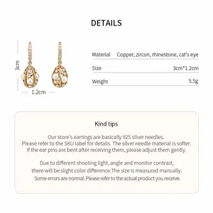 Macro view of 14k gold plated drop earrings showing product size and material specs