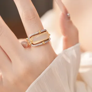 Close-up of elegant gold zircon-encrusted ring with rectangular center stone
