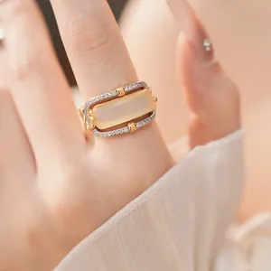 Close-up detail of a vintage hollow ring with rectangular stone and zircon inlay