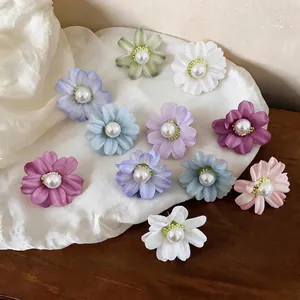 Elegant fabric flower stud earrings with pearl centers in various colors for women.