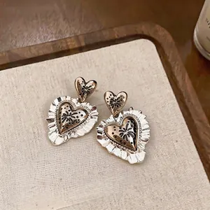 Vintage heart-shaped drop earrings with elegant ruffled lace border and silver needles