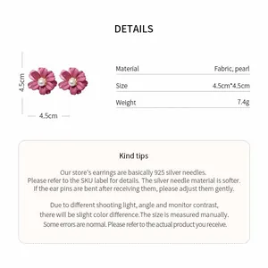 Macro detail of pink fabric flower earrings with pearl centers and 925 silver needles.