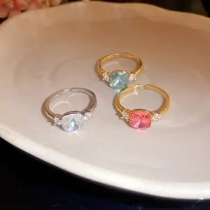 Detailed view of square-cut zircon rings with adjustable open bands in various colors