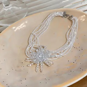 French vintage multi-layer pearl necklace with fireworks crystal pendant on tray