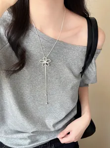 Detail view of a French style silver zircon hollow flower necklace with long tassel