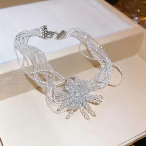 Elegant French retro multi-strand pearl choker with a sparkling firework starburst pendant