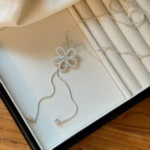 Exquisite detail of silver hollow flower necklace with zircon center and snake chain