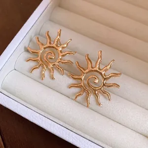 Elegant gold hollow sun stud earrings with spiral design for a minimalist fashion look