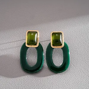 Vintage dunkelgrüne Harzohrringe quadratisch und oval mit goldfarbenem Rahmen.