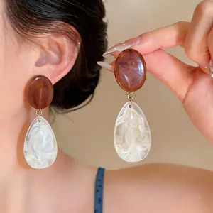 Vintage Maillard style resin drop earrings with brown oval and marbled teardrop