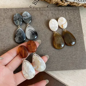 Vintage-inspired resin teardrop earrings featuring marbled patterns and earthy tones