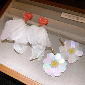 Romantic fabric flower tassel earrings and iridescent sequin daisy studs for beach vacations.