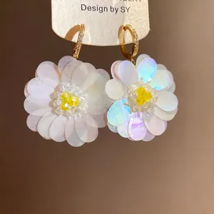 Elegant white sequin flower hoop earrings with yellow beaded centers for vacation.