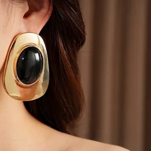 Elegant vintage gold earrings with large black oval stone inlay for luxury fashion