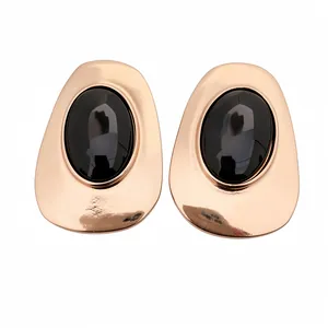 Exquisite rose gold stud earrings featuring a large black faceted oval gemstone