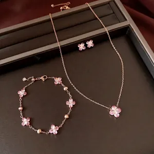 Elegant rose gold jewelry set with pink zircon flower motifs including necklace and bracelet