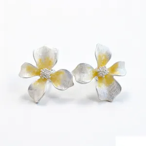 Elegant silver-toned floral stud earrings with vibrant yellow enamel finish for women
