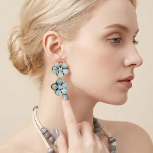 Elegant blue enamel flower drop earrings featuring sparkling rhinestone centers