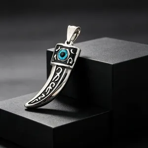 Detailed view of punk stainless steel wolf tooth pendant featuring a blue evil eye bead