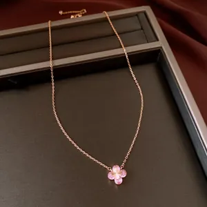 Close-up of rose gold necklace with a pink zircon flower pendant on display