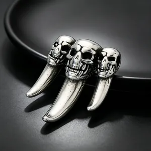Macro detail shot of a punk hip-hop stainless steel wolf fang pendant with skulls.