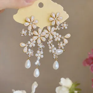 Detailed view of elegant French court style floral earrings with teardrop pearls