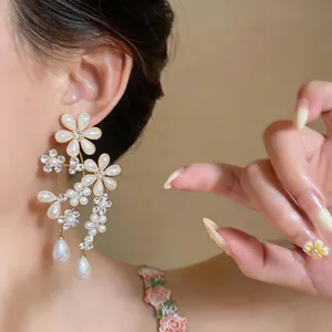 Close-up view of elegant French vintage floral pearl earrings with teardrop drops
