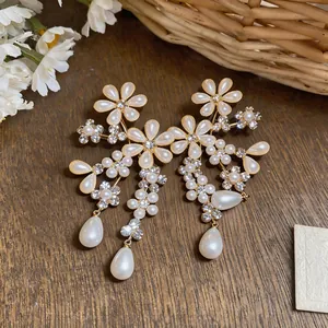 Detailed view of French palace style floral earrings with pearls and rhinestones