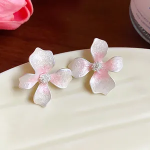 Detailed view of fresh pink gradient flower stud earrings with glitter enamel
