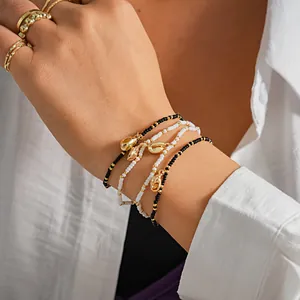 Handmade bohemian seed bead bracelet set with golden sea shell charms for women