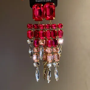 Close-up of pink and clear rhinestone chandelier earrings with square fringe design