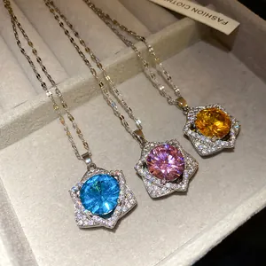 Detail showing trio of star-shaped necklaces with blue, pink, and yellow crystals