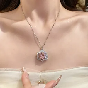 Detail view of a luxury star pendant necklace with a large pink center gemstone.