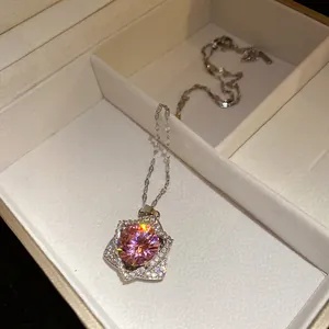 Macro view of pink star pendant necklace with micro-pave stones in a jewelry box